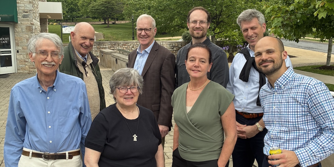 Sr. Mary Kate Birge stands with Faculty in the Theology Department
