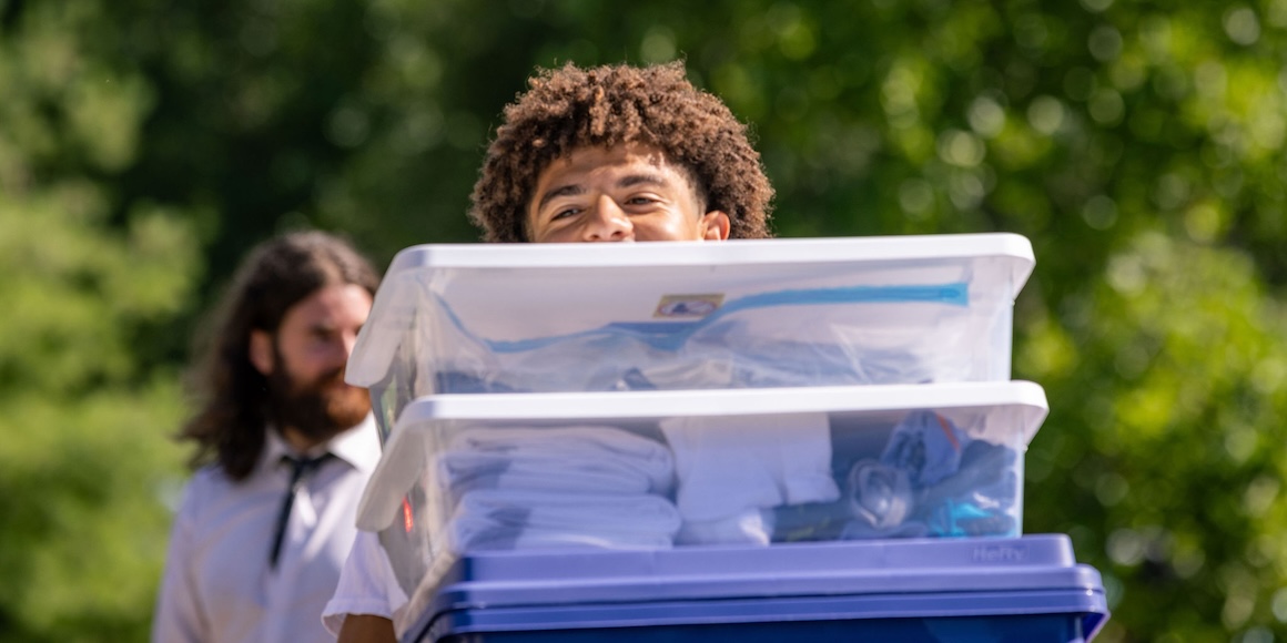 Student carrying boxes